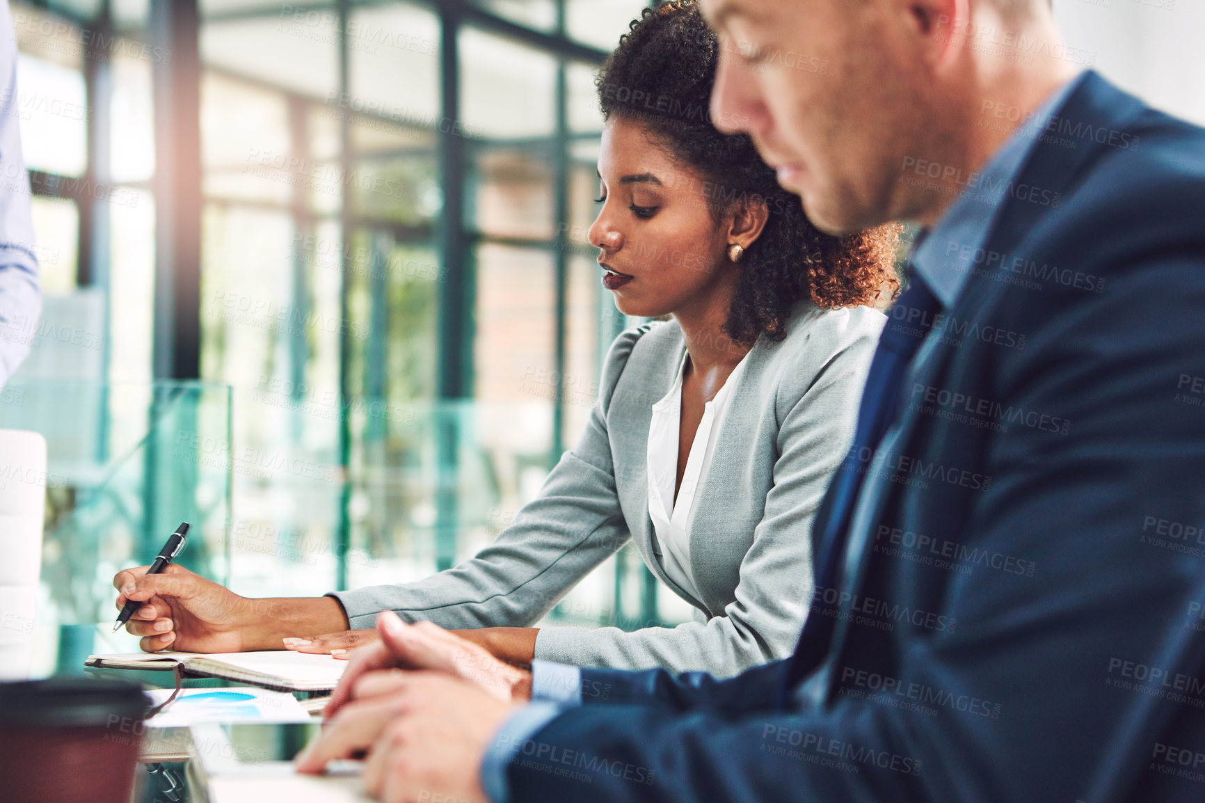 Buy stock photo Cropped shot of two corporate businesspeople working together in an office