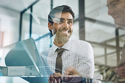 Buy stock photo Shot of two businessmen using a laptop together at work