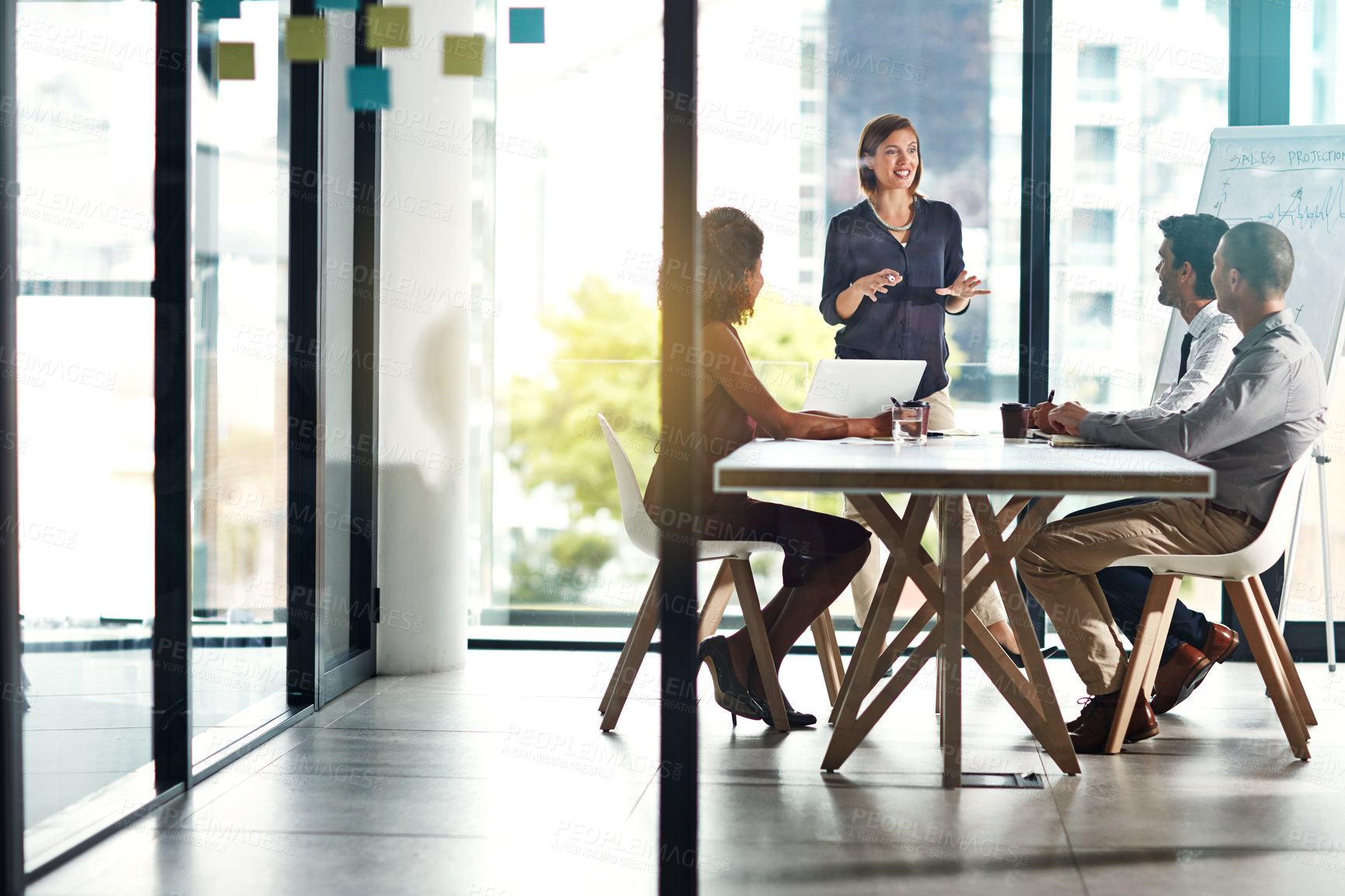 Buy stock photo Presentation, meeting and business people in office building for planning, marketing strategy and goals. Leadership, teamwork and woman speaking to workers for our vision, target and ideas at desk