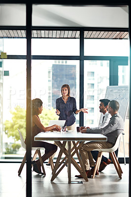 Buy stock photo Shot of a group of colleagues having a meeting in a modern office