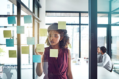 Buy stock photo Shot of a young businesswoman having a brainstorming session at work