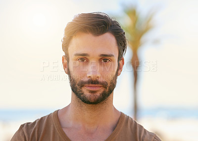 Buy stock photo Portrait of a handsome young man standing outside on a sunny day