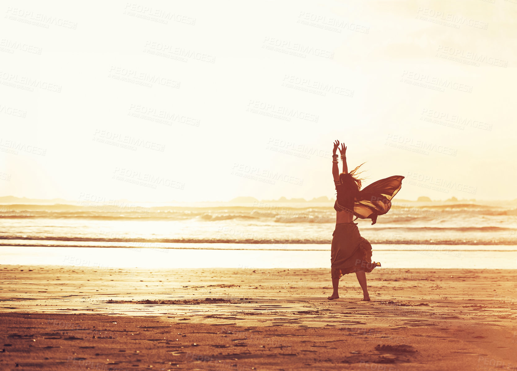 Buy stock photo Shot of a young woman enjoying a day at the beach