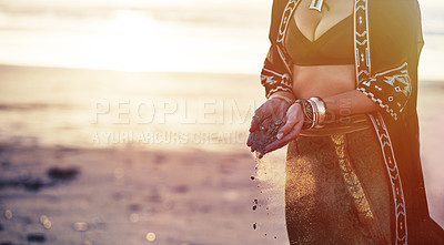 Buy stock photo Cropped shot of a young woman on the beach holding sand in her hands