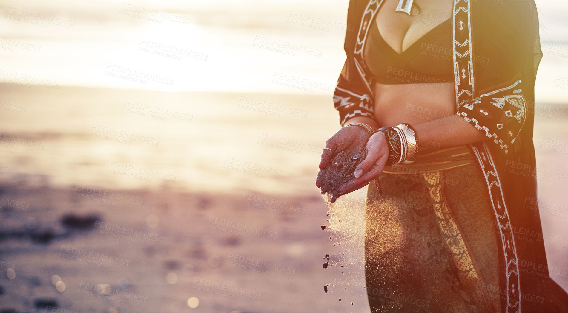 Buy stock photo Cropped shot of a young woman on the beach holding sand in her hands