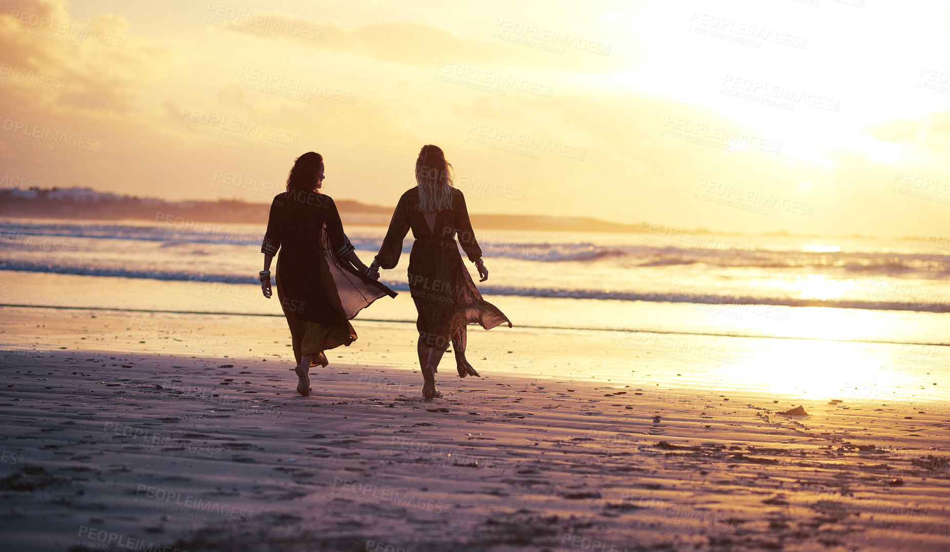 Buy stock photo Lesbian, silhouette or women at beach with hands together, sunset or anniversary celebration on tropical trip. Honeymoon, back or couple with romance, LGBTQ connection or summer evening in Brazil.