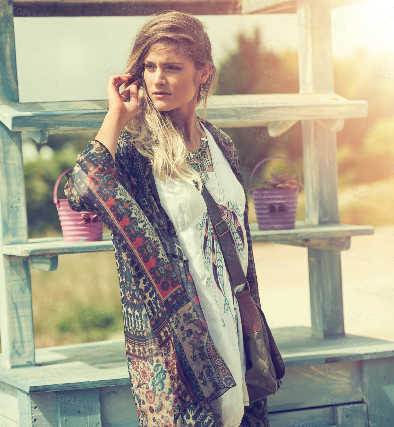 Buy stock photo Shot of a bohemian young woman spending a summer day outside