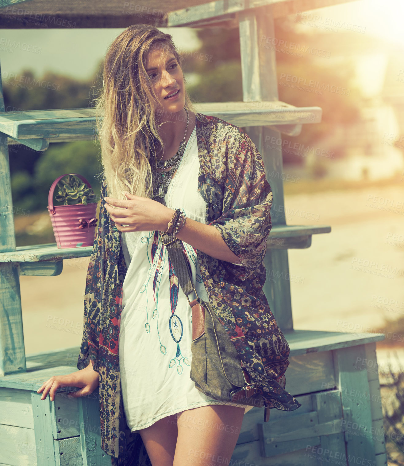 Buy stock photo Shot of a free spirited young woman enjoying the sunshine outside