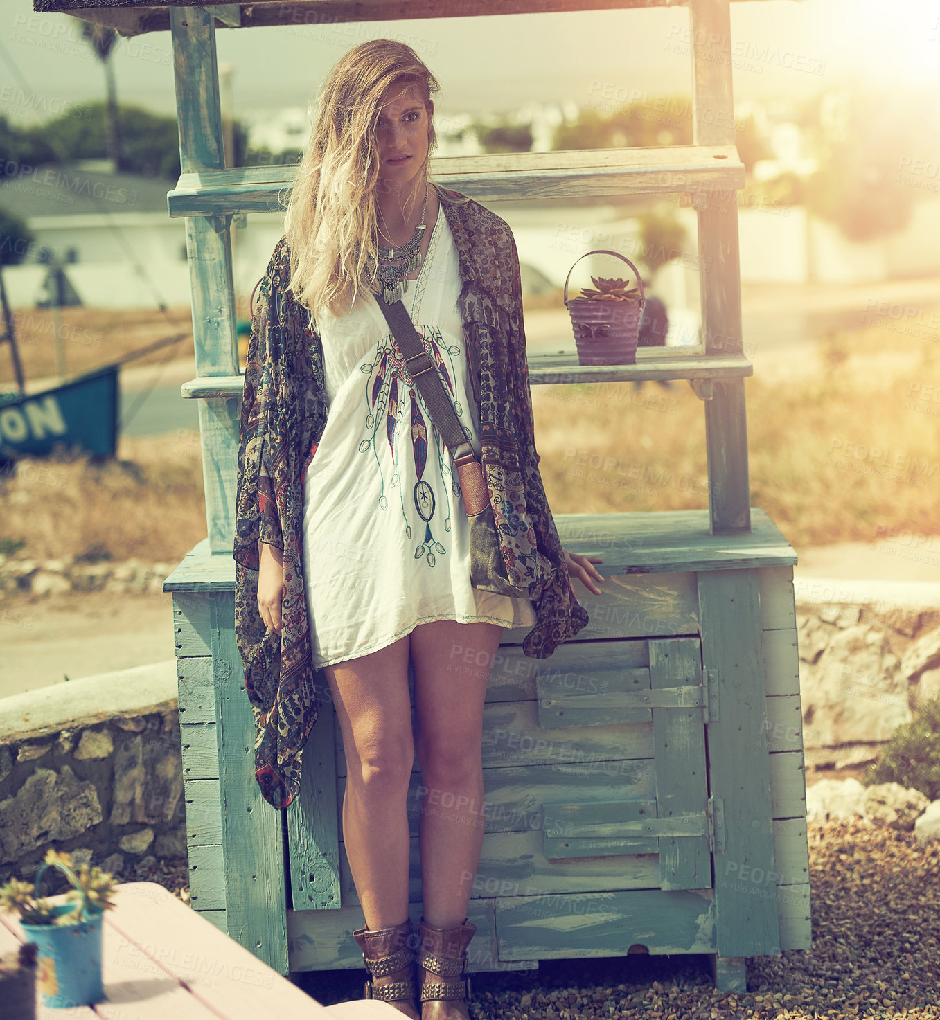 Buy stock photo Shot of a fashionable young woman posing outside on a sunny day