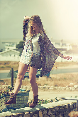 Buy stock photo Shot of a bohemian young woman spending a summer day outside