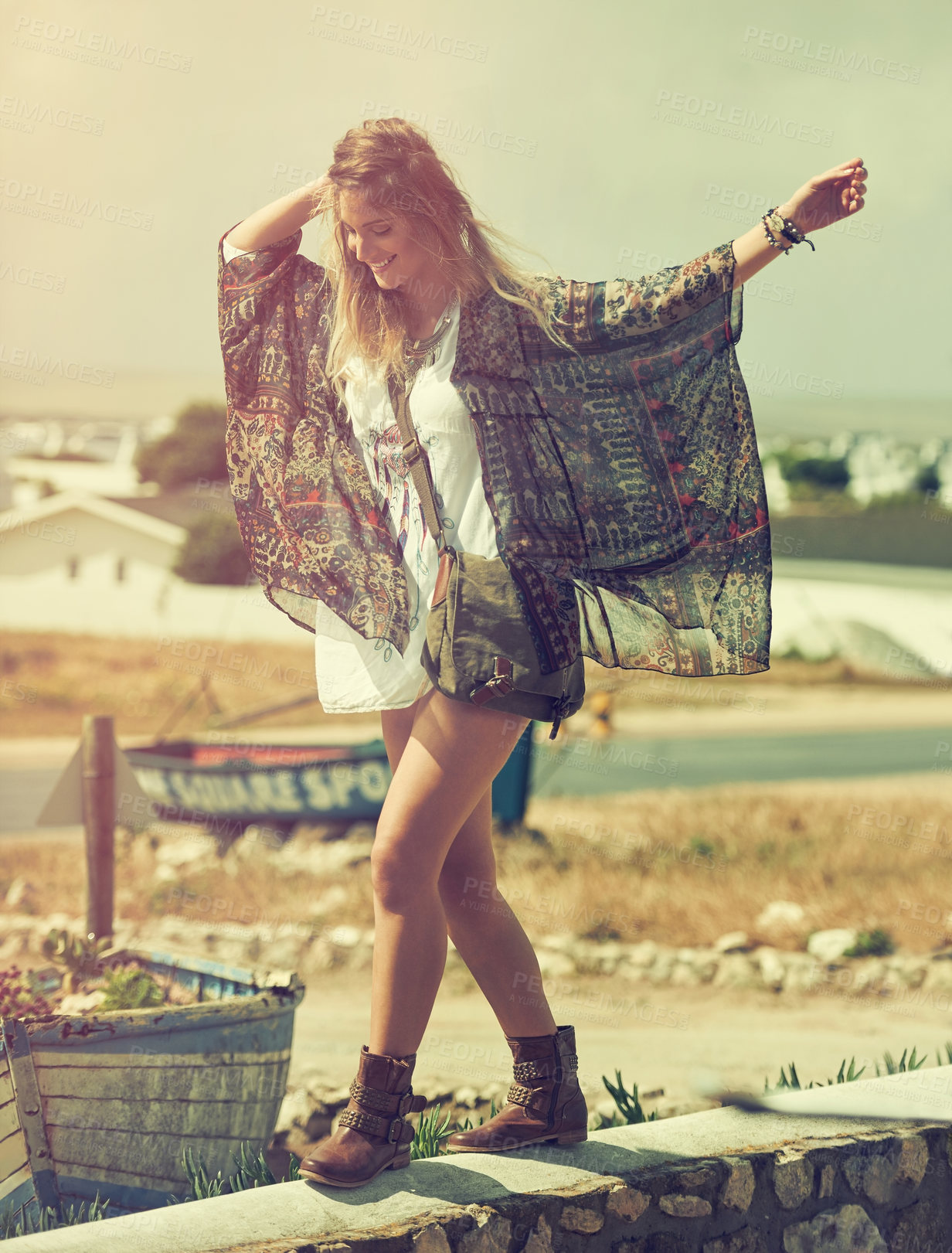 Buy stock photo Shot of a free spirited young woman enjoying the sunshine outside