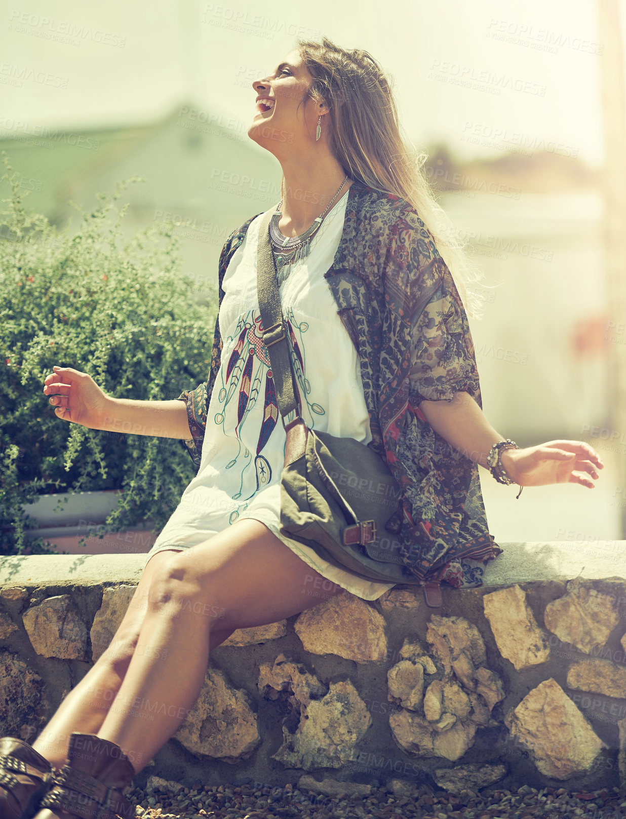 Buy stock photo Shot of a free spirited young woman enjoying the sunshine outside