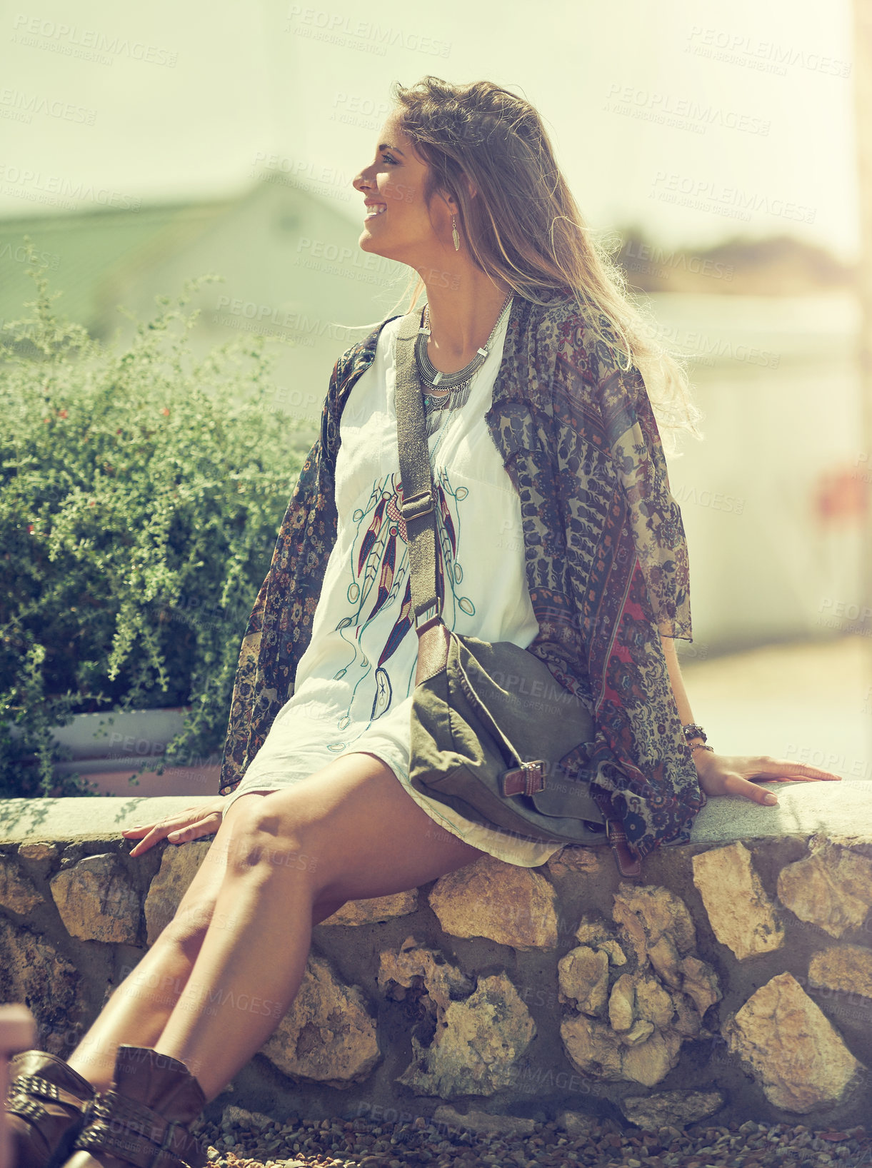 Buy stock photo Shot of a free spirited young woman enjoying the sunshine outside