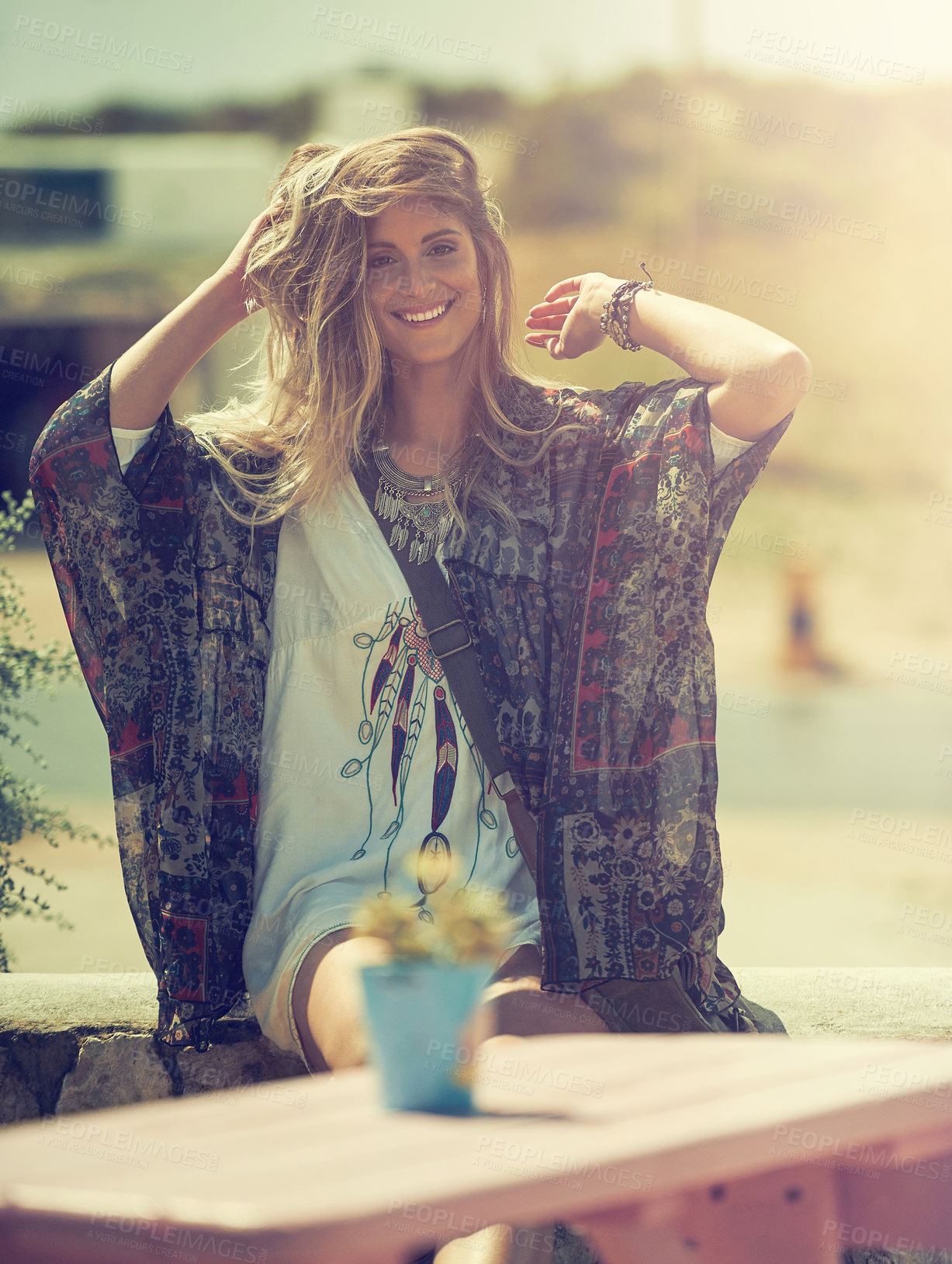 Buy stock photo Shot of a bohemian young woman spending a summer day outside