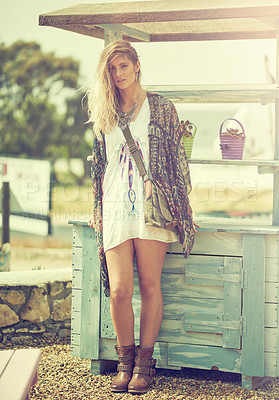 Buy stock photo Shot of a fashionable young woman posing outside on a sunny day