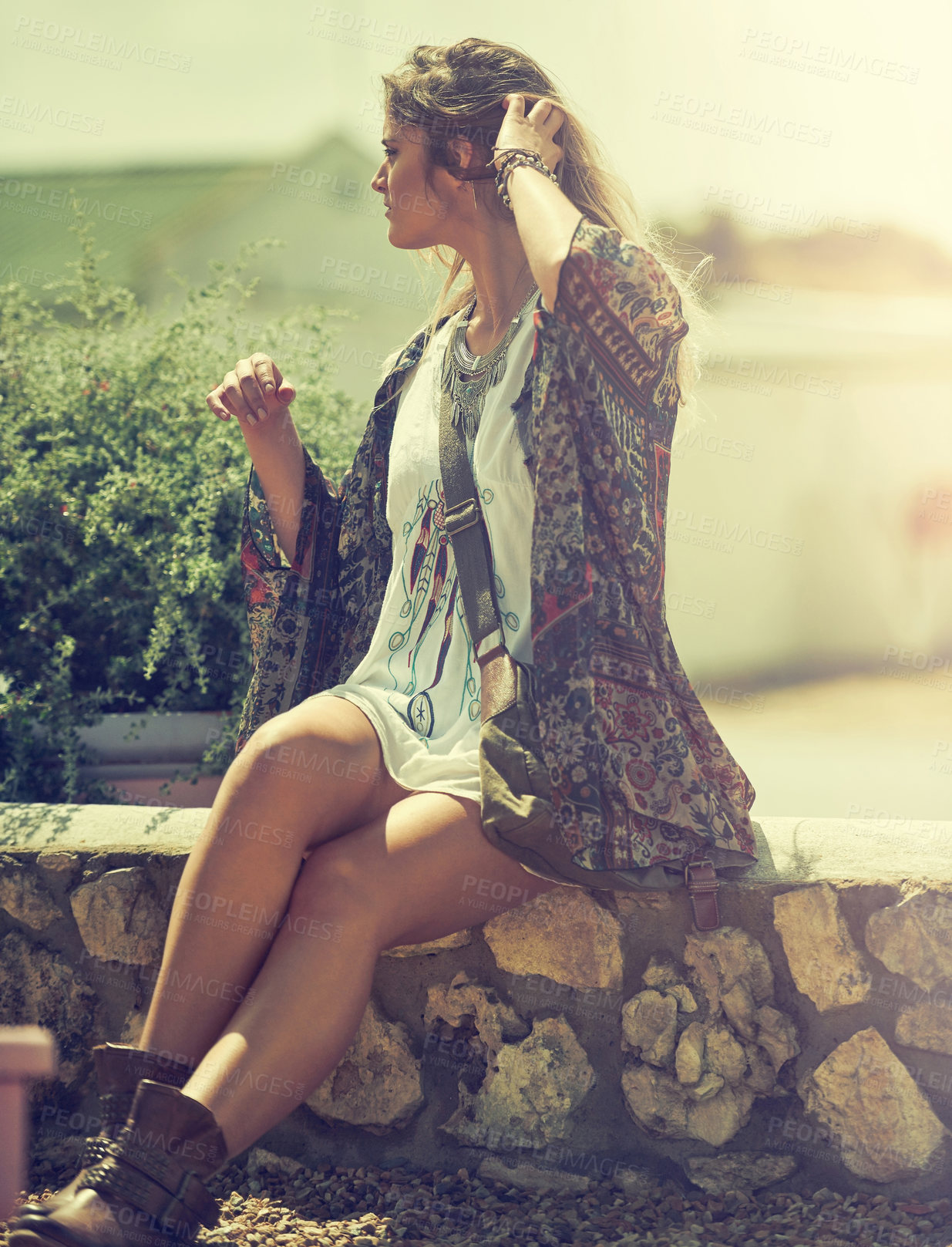 Buy stock photo Shot of a bohemian young woman spending a summer day outside