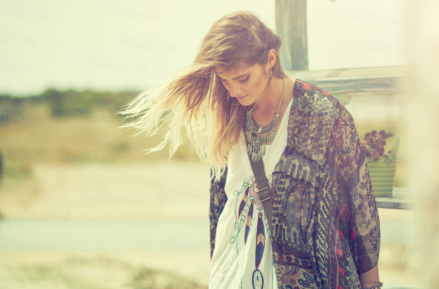 Buy stock photo Shot of a bohemian young woman spending a summer day outside