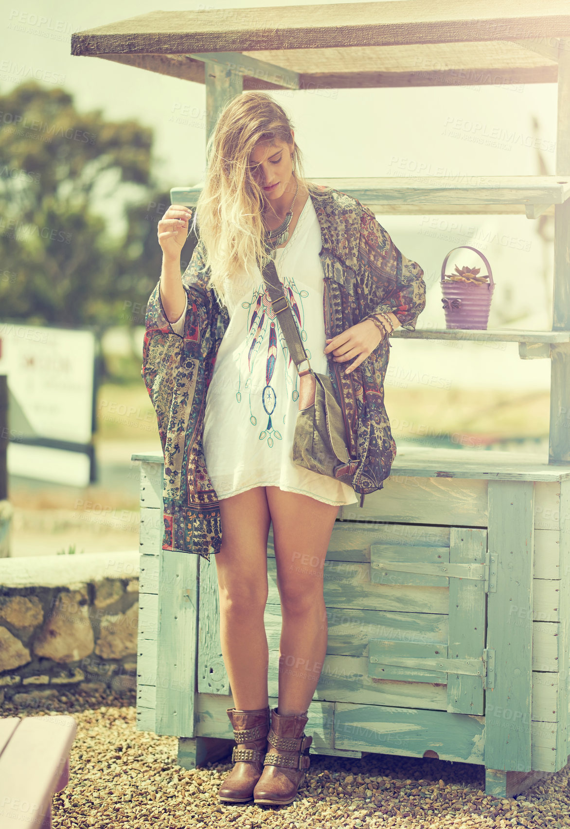 Buy stock photo Shot of a fashionable young woman posing outside on a sunny day