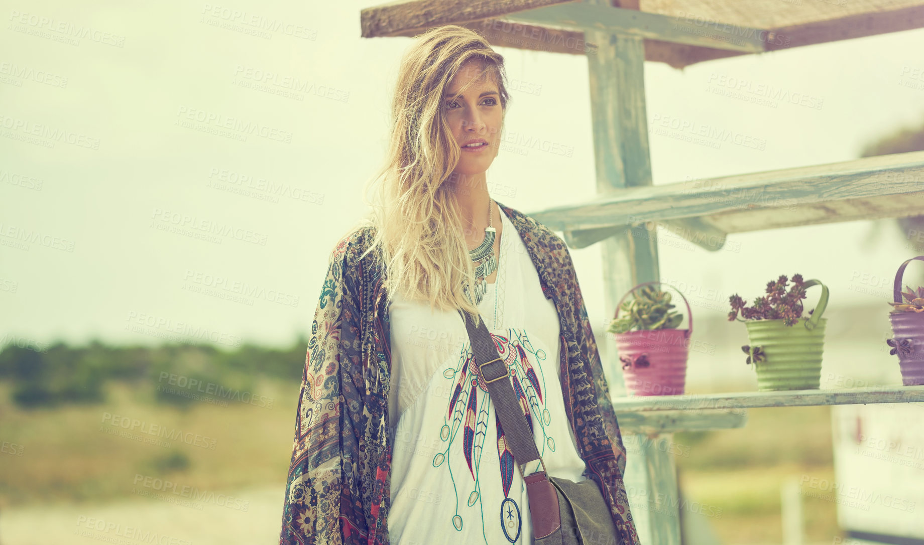 Buy stock photo Shot of a fashionable young woman posing outside on a sunny day