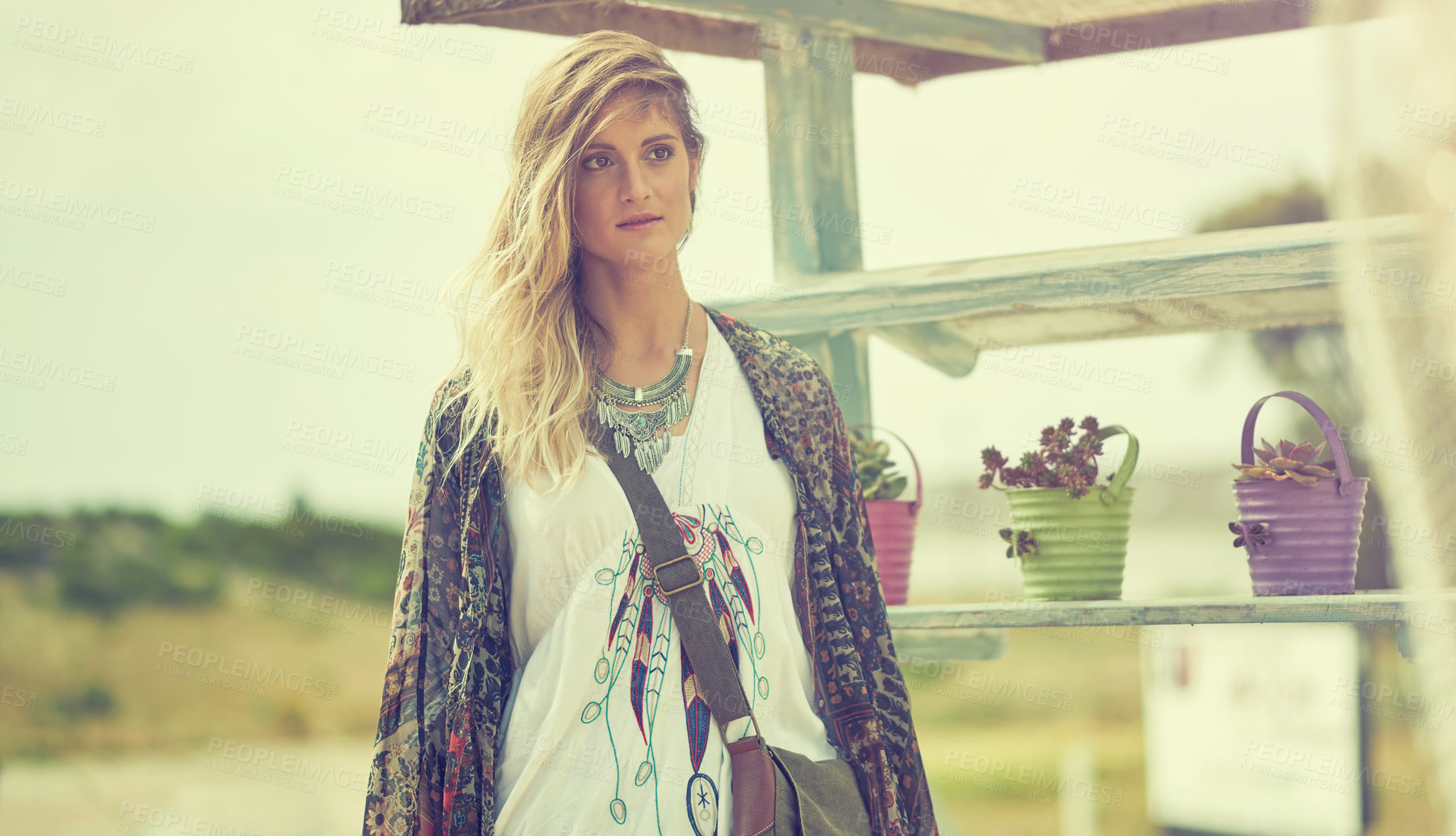 Buy stock photo Shot of a fashionable young woman posing outside on a sunny day