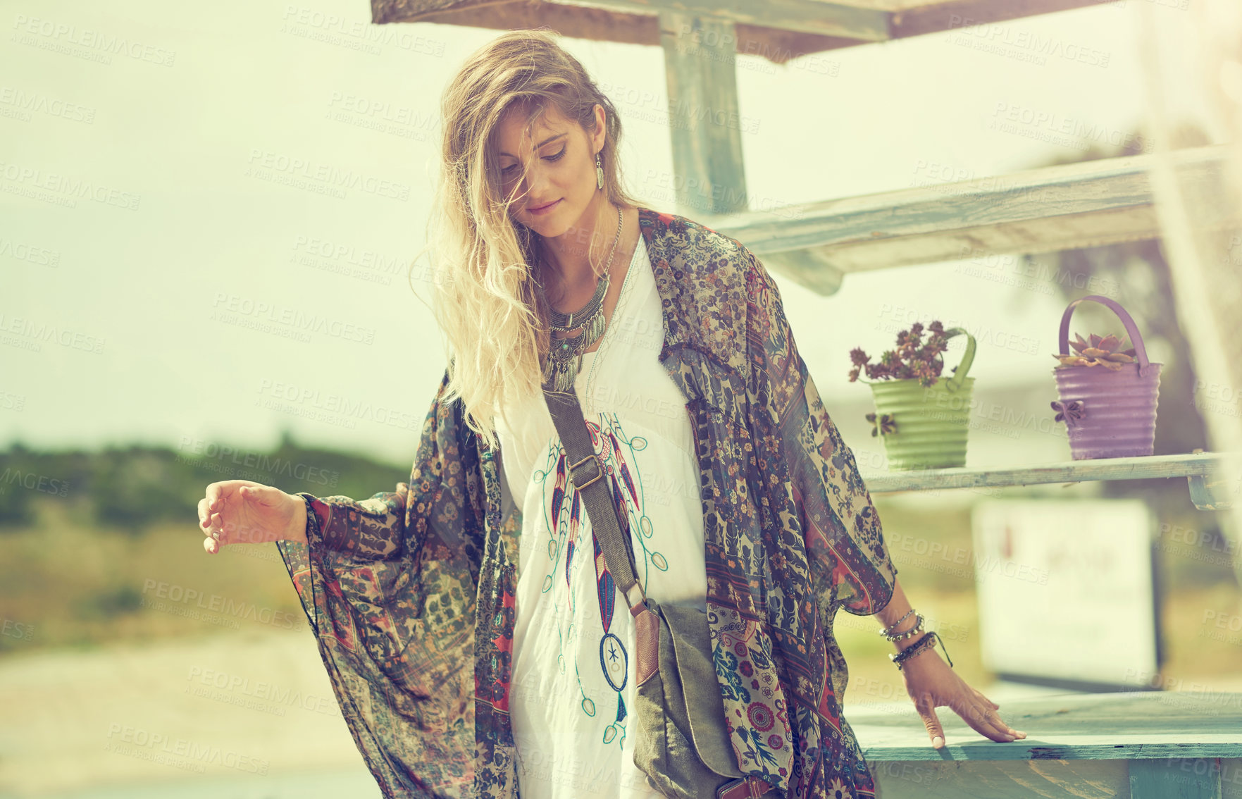 Buy stock photo Shot of a free spirited young woman enjoying the sunshine outside