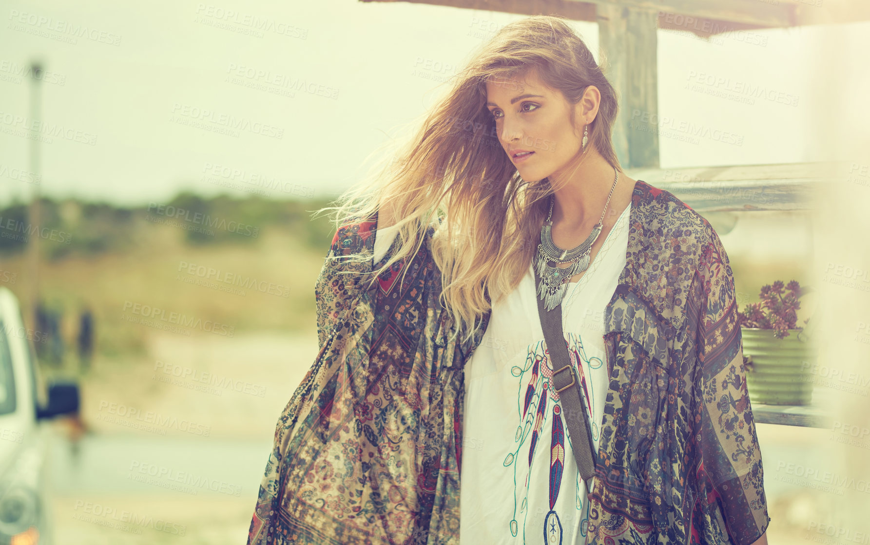 Buy stock photo Shot of a bohemian young woman spending a summer day outside