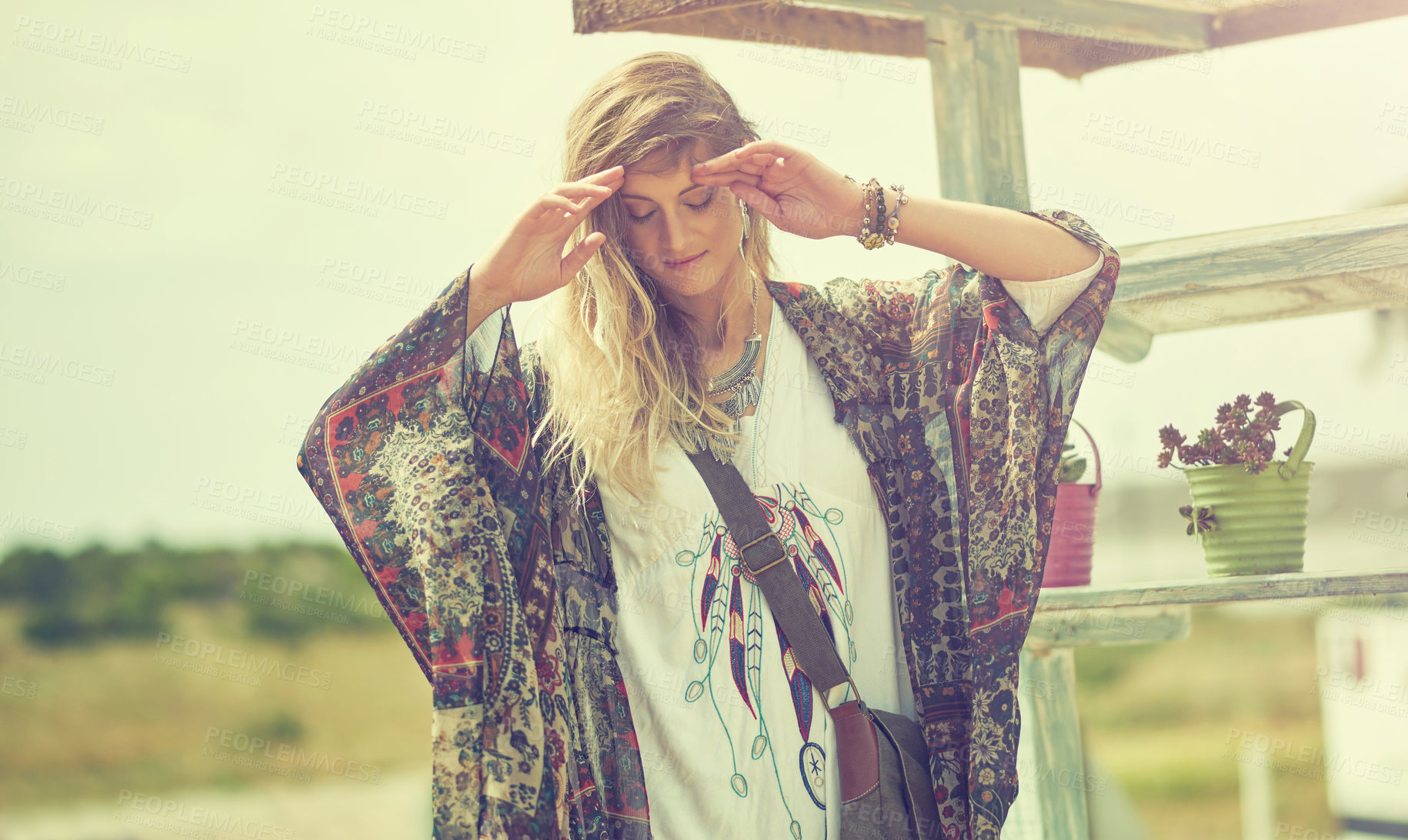 Buy stock photo Shot of a bohemian young woman spending a summer day outside