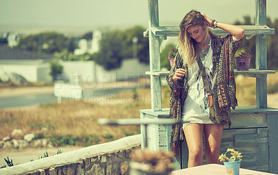 Buy stock photo Shot of a free spirited young woman enjoying the sunshine outside