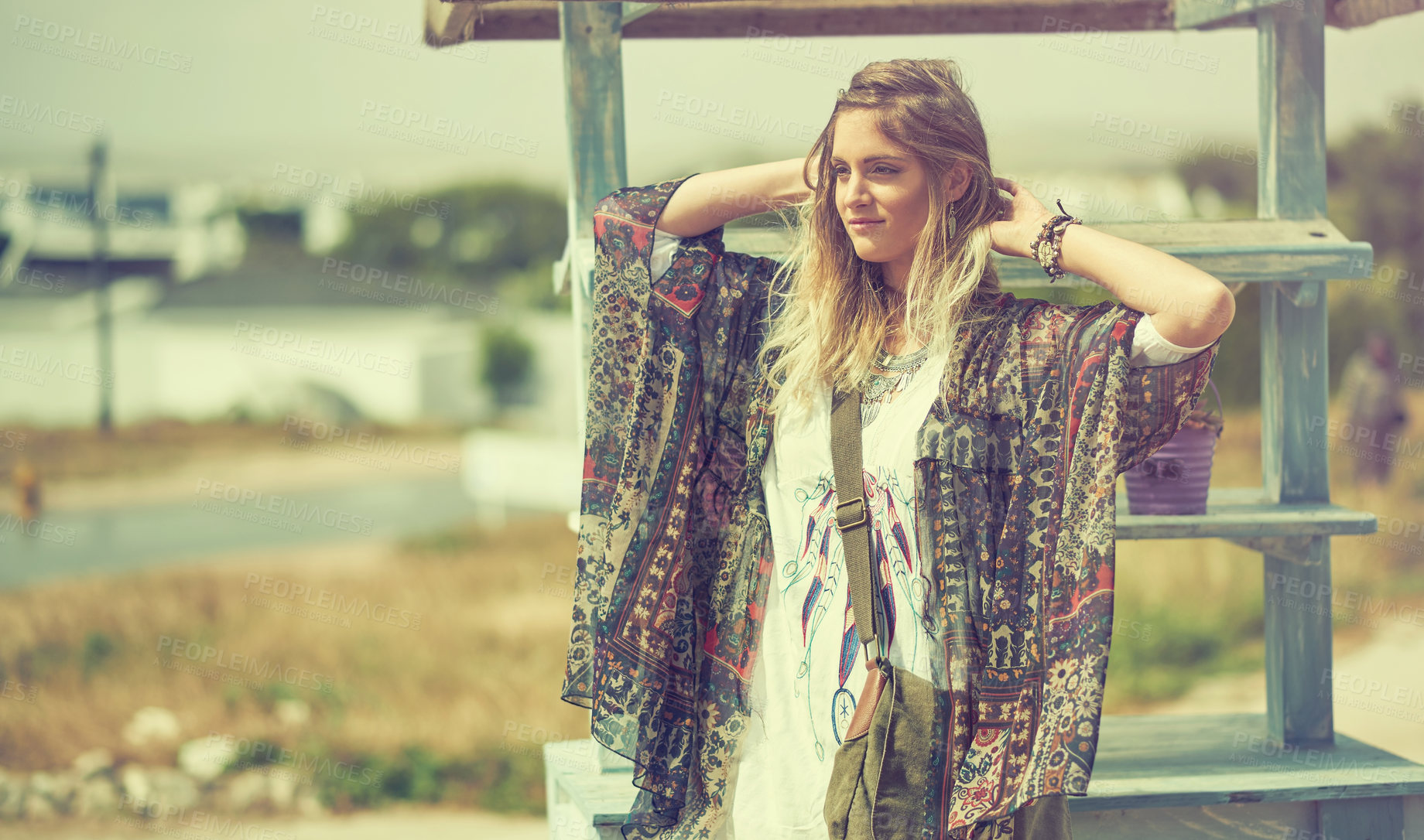 Buy stock photo Shot of a bohemian young woman spending a summer day outside