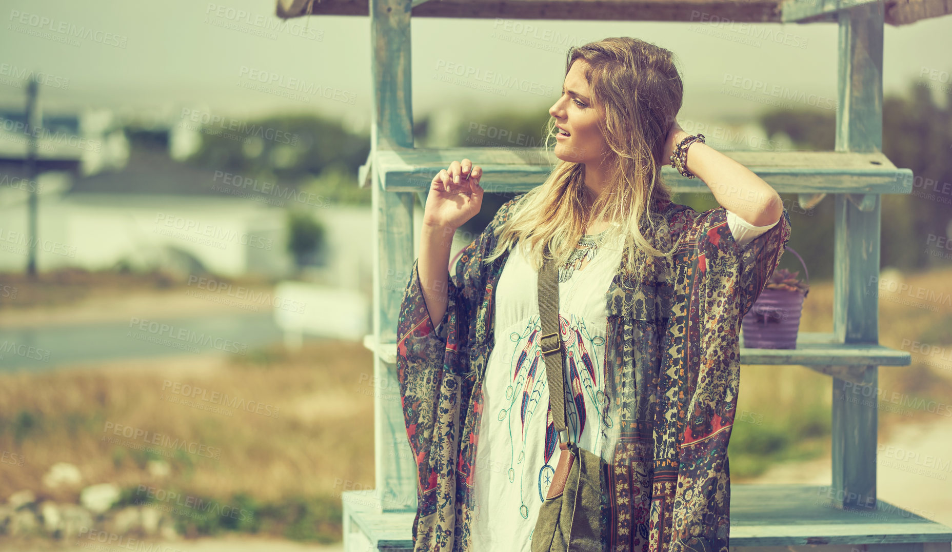 Buy stock photo Shot of a bohemian young woman spending a summer day outside