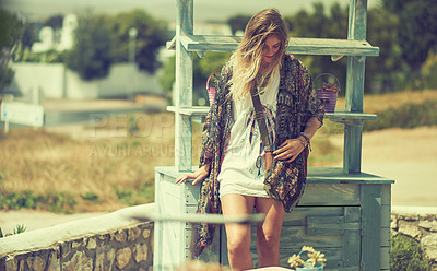 Buy stock photo Shot of a bohemian young woman spending a summer day outside