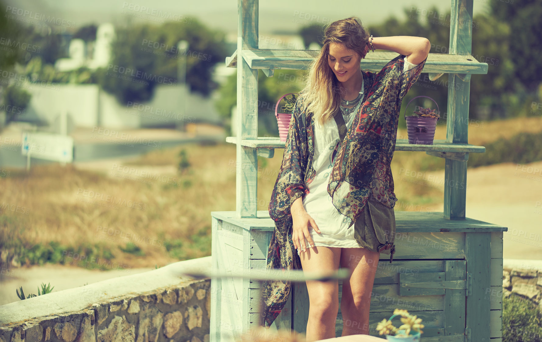 Buy stock photo Shot of a fashionable young woman posing outside on a sunny day