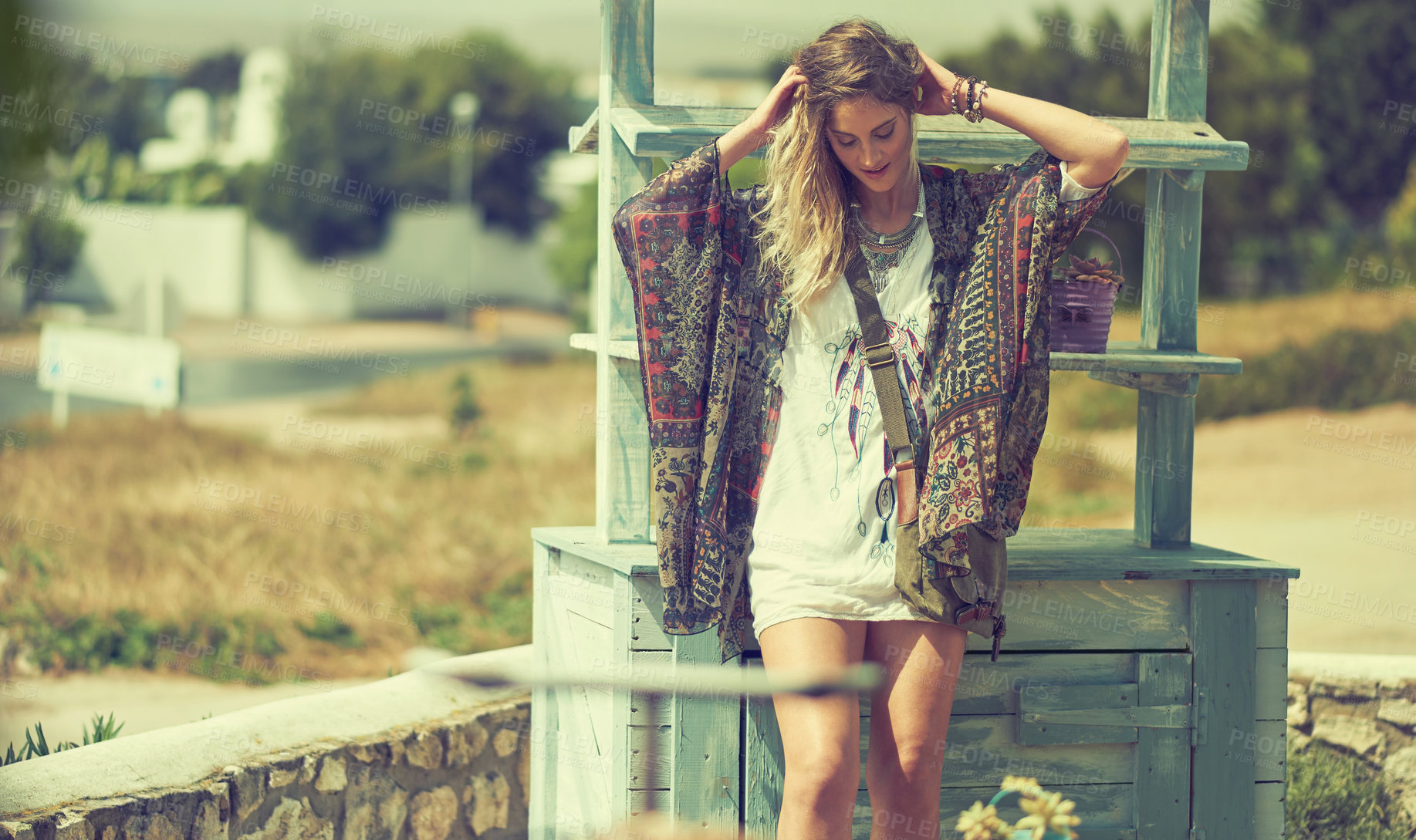 Buy stock photo Shot of a free spirited young woman enjoying the sunshine outside