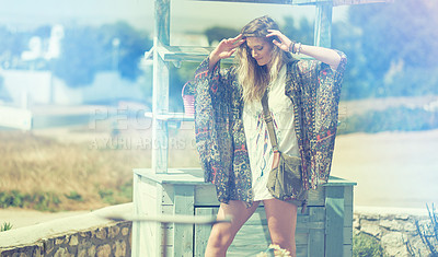 Buy stock photo Shot of a bohemian young woman spending a summer day outside