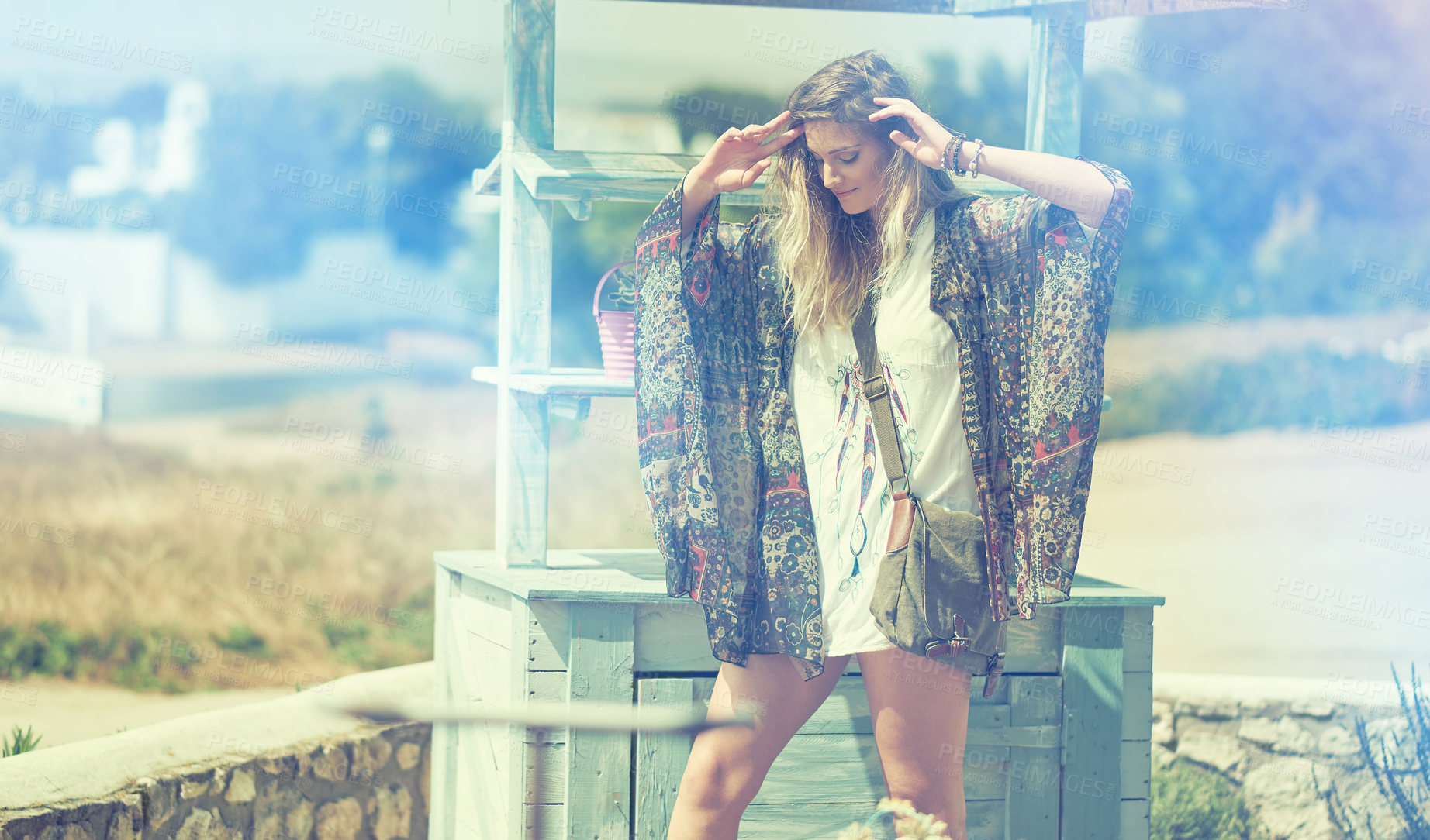 Buy stock photo Shot of a bohemian young woman spending a summer day outside