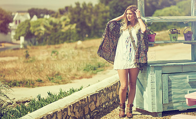 Buy stock photo Shot of a fashionable young woman posing outside on a sunny day