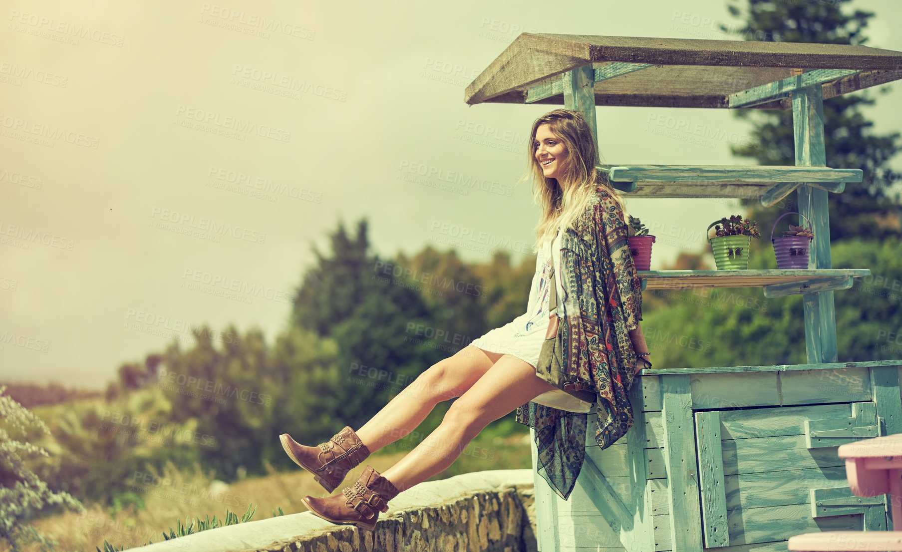 Buy stock photo Shot of a free spirited young woman enjoying the sunshine outside