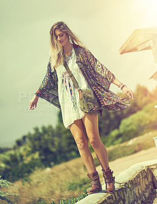 Buy stock photo Shot of a free spirited young woman enjoying the sunshine outside