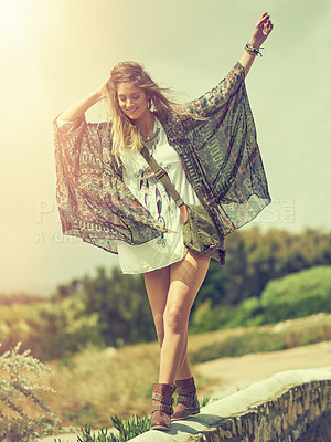 Buy stock photo Shot of a free spirited young woman enjoying the sunshine outside