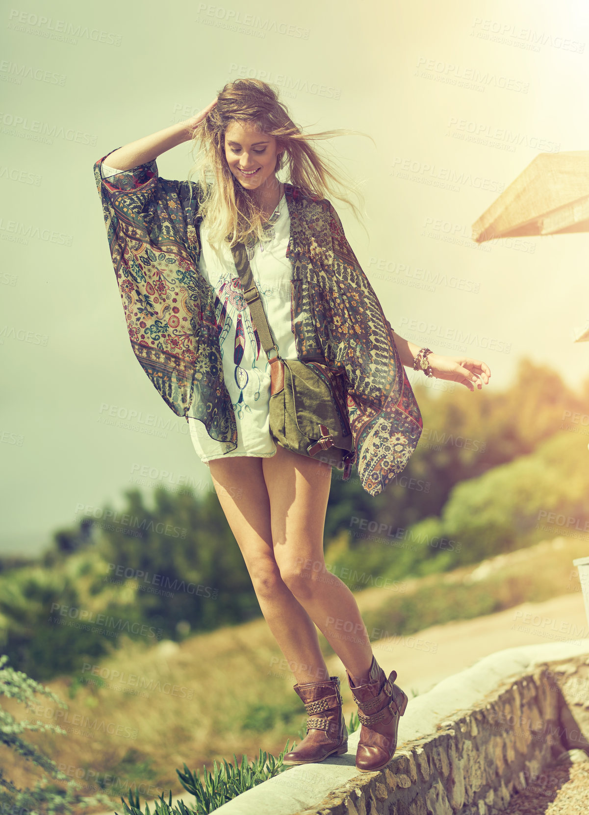 Buy stock photo Shot of a free spirited young woman enjoying the sunshine outside