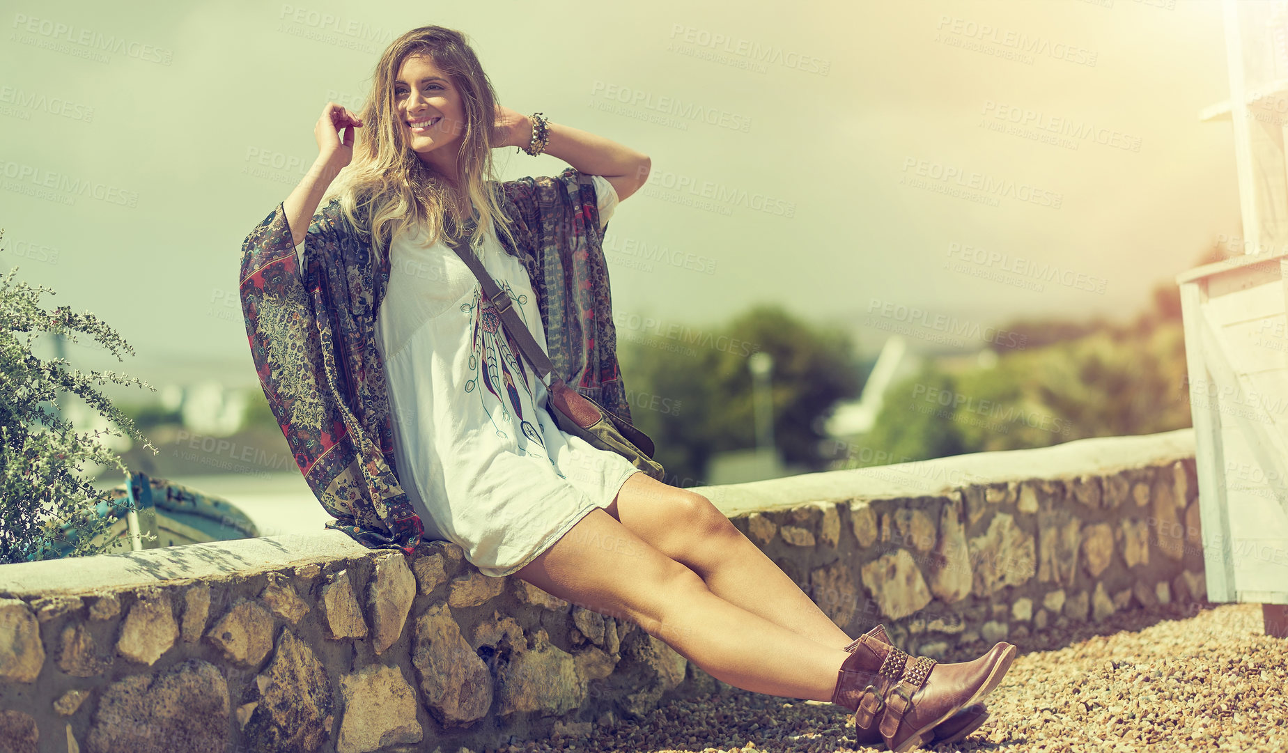 Buy stock photo Shot of a free spirited young woman enjoying the sunshine outside