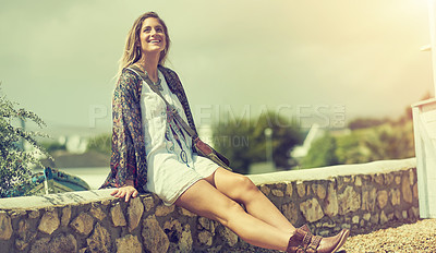 Buy stock photo Shot of a free spirited young woman enjoying the sunshine outside