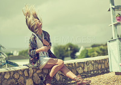 Buy stock photo Shot of a bohemian young woman spending a summer day outside