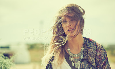 Buy stock photo Shot of a fashionable young woman posing outside on a sunny day