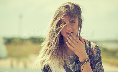 Buy stock photo Shot of a fashionable young woman posing outside on a sunny day