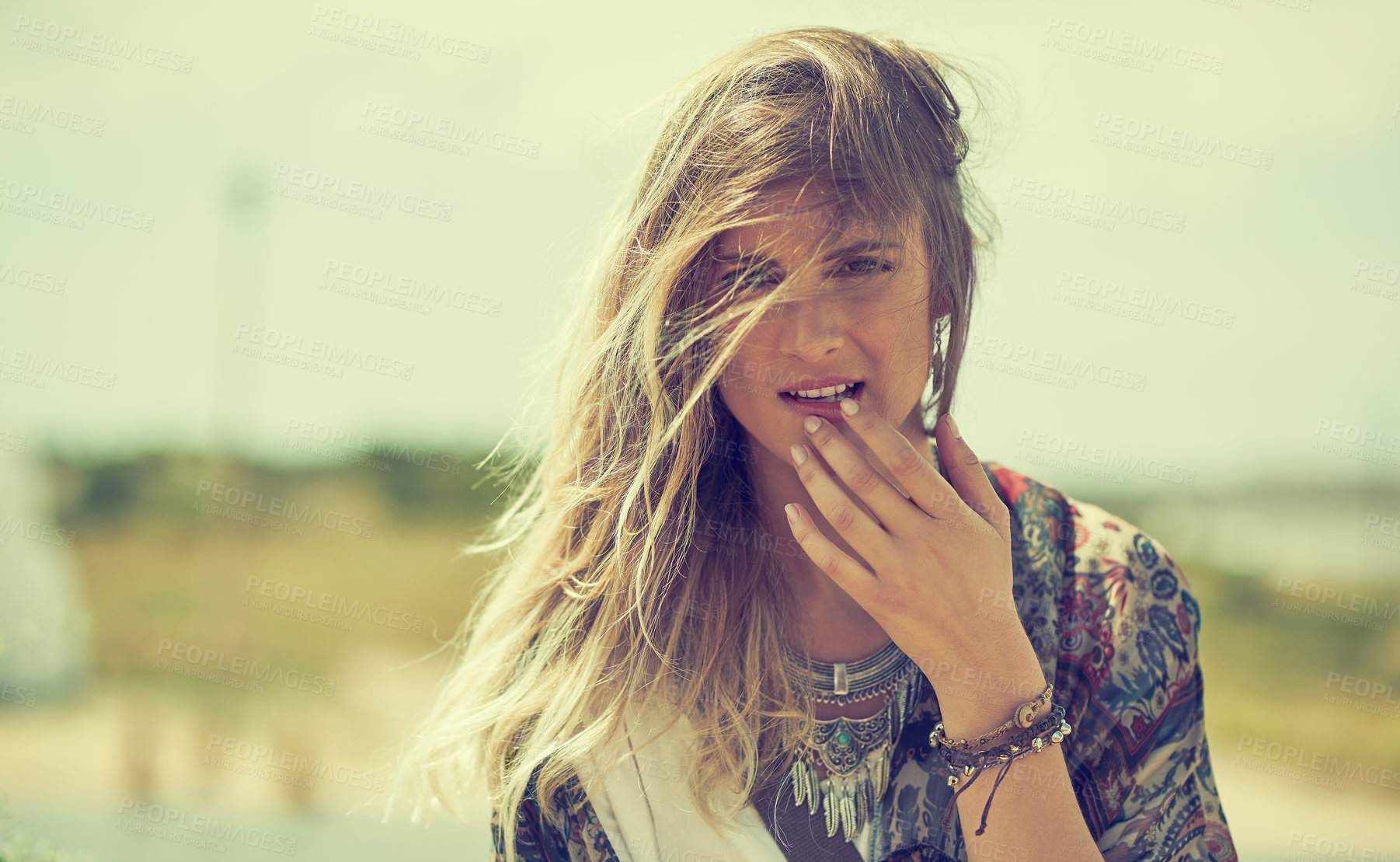 Buy stock photo Shot of a fashionable young woman posing outside on a sunny day