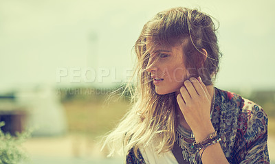 Buy stock photo Shot of a fashionable young woman posing outside on a sunny day