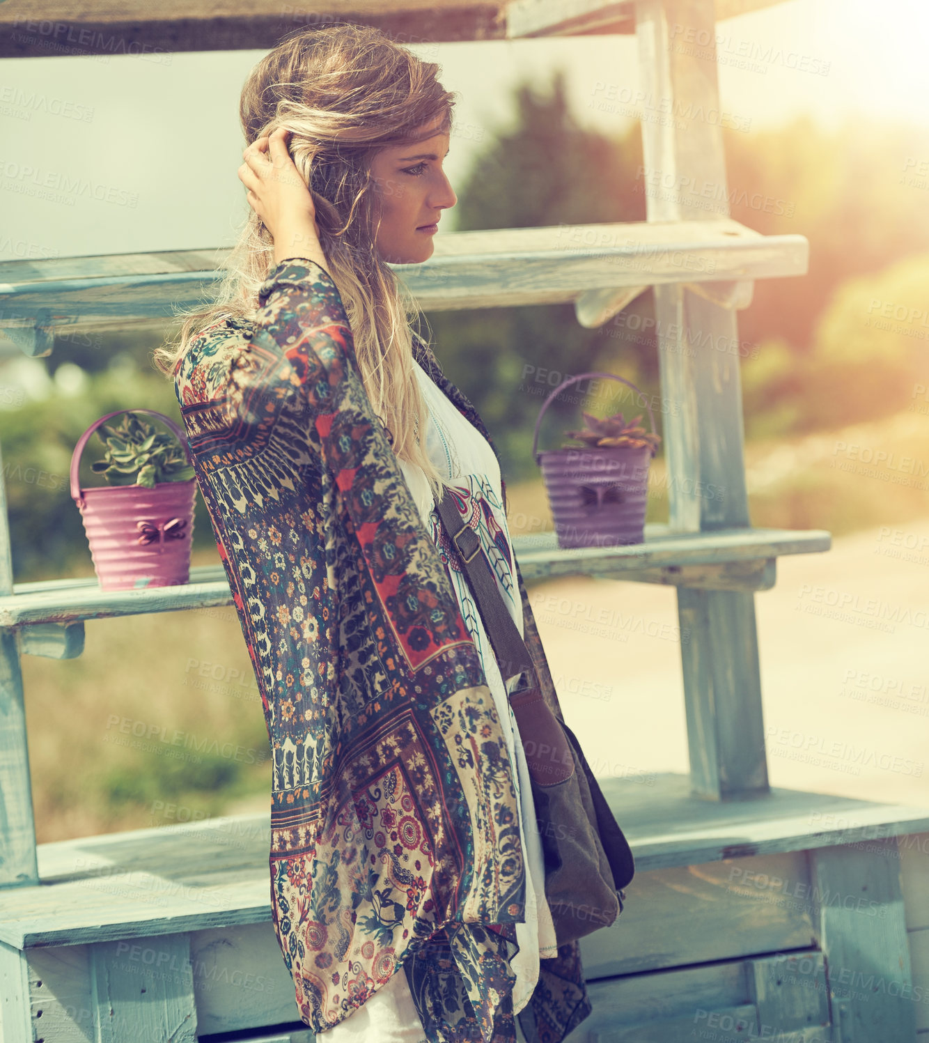 Buy stock photo Shot of a bohemian young woman spending a summer day outside