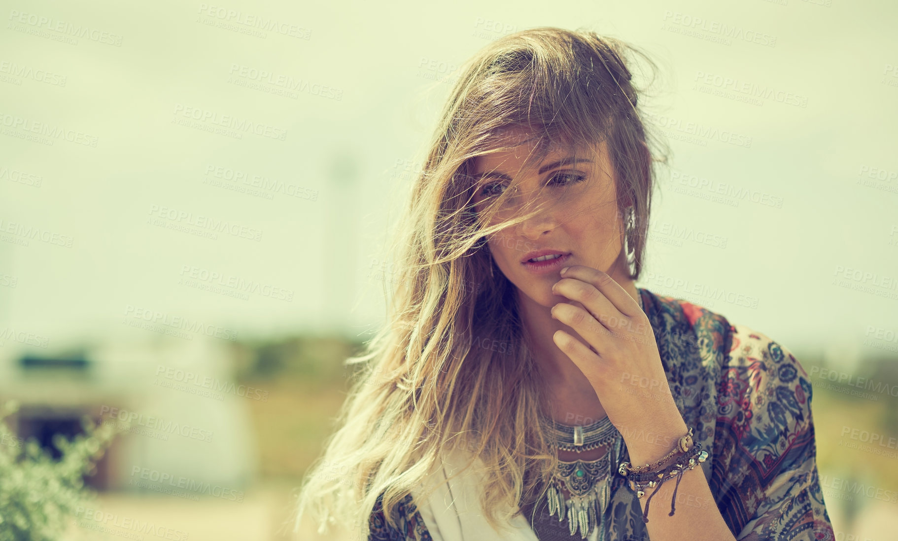 Buy stock photo Shot of a fashionable young woman posing outside on a sunny day