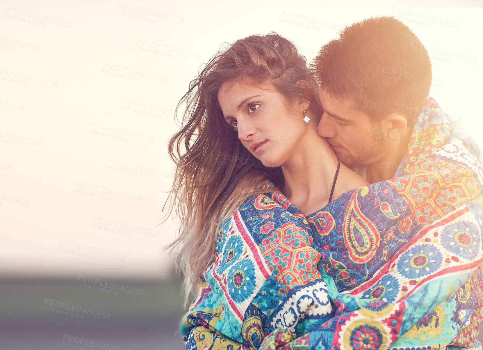 Buy stock photo Shot of an affectionate young couple at the beach